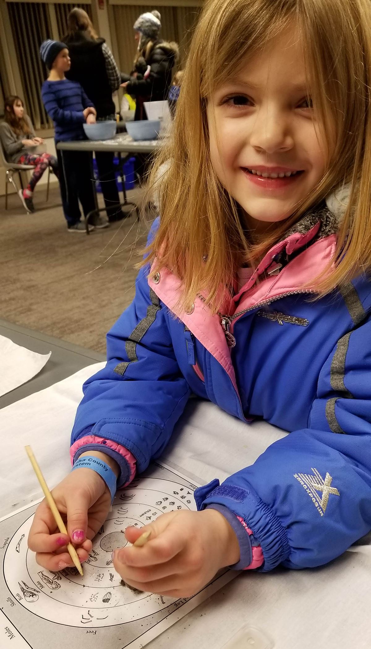 Young participant at Wild Winter Night drawing a picture
